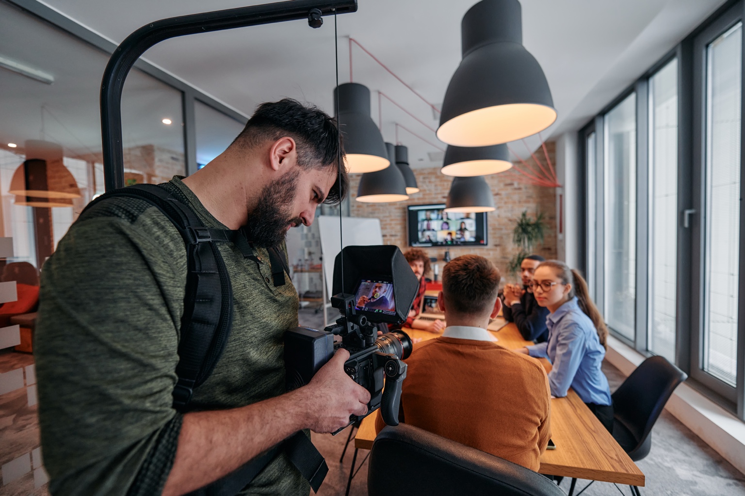 Videographer filming corporate meeting